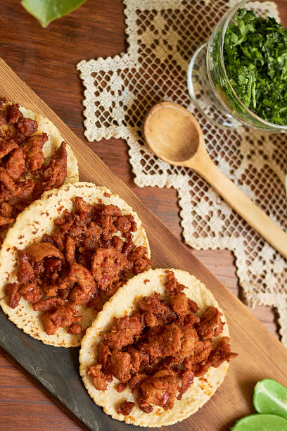 istock Authentic Mexican tacos on wooden table. Mexican gastronomy concept. 1328872674