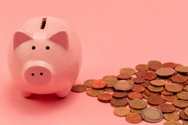 Saving Saving money with a piggy bank netherlands currency stock pictures, royalty-free photos & images