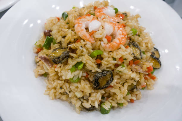 istock Fried rice with shrimp on the white dish on wooden table. 1328874008