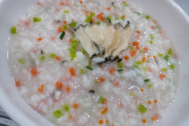 istock porridge rice with vegetable with abalone on the white dish. 1328874017