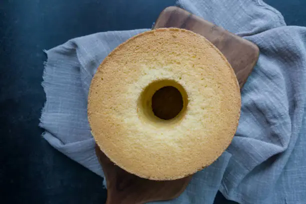 Photo of Chiffon cake on a wood cutting board.