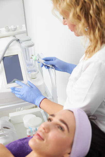istock Professional cosmetologist is doing procedures for client in light cabinet 1328876064