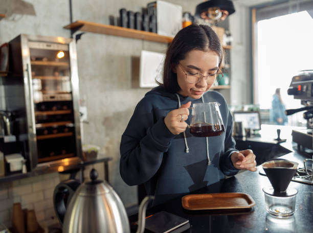istock Happy smiling professional barista in cafe 1328876415