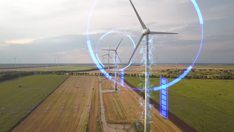 Aerial view of wind turbine generators in field producing clean ecological electricity. Digital effect of futuristic technology.