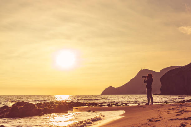 istock Woman with camera on Monsul beach, Spain 1328878826