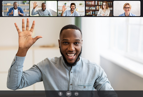 Communication. Laptop webcam screen view of multiethnic men and women contacting distantly by videoconference. Smiling diverse employees making video call using modern app for virtual interaction
