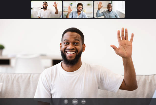 istock Youn men making online videochat at home, waving hands 1328878875