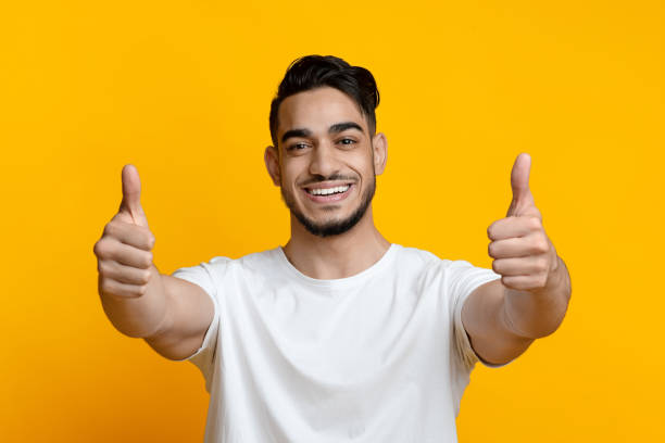 istock Positive arab guy showing thumbs up at camera 1328879078