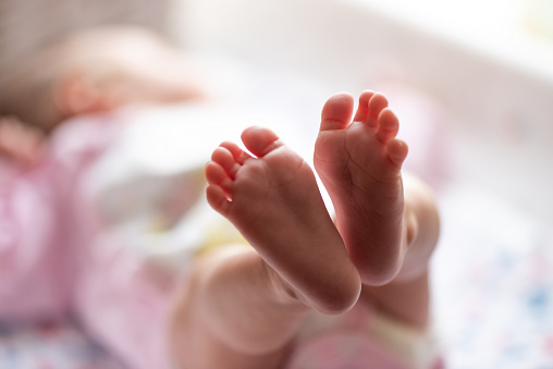 Cute little feet of newborn baby