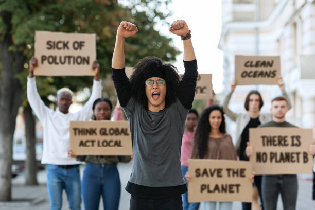 istock Black guy leader leading international group of protestors 1328879478