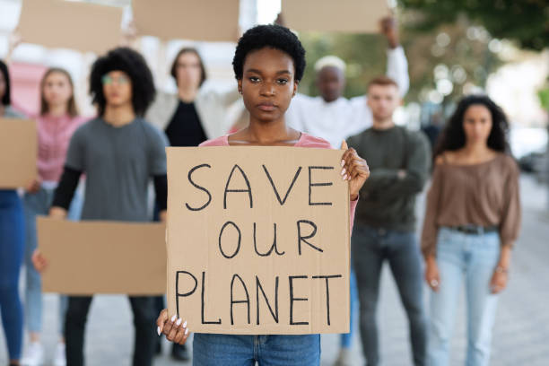 istock Black woman holding placard save our planet 1328880042