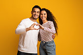 Portrait Of Romantic Arabic Couple Making Heart Gesture With Hands Together