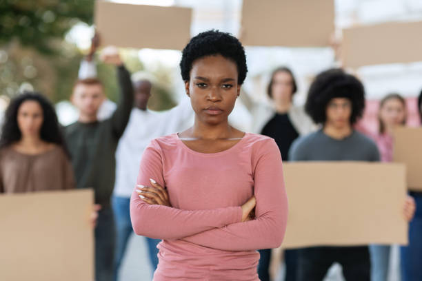 istock Angry black lady leading multiracial group of protestors 1328880052