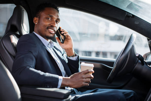 istock African businessman having mobile talk while sitting in car 1328883125