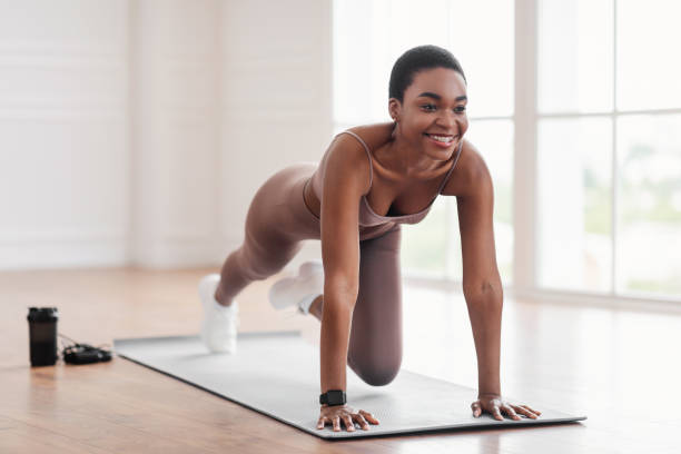 istock Black Cheerful Woman Doing Cross Body Mountain Climbers Exercise 1328883255