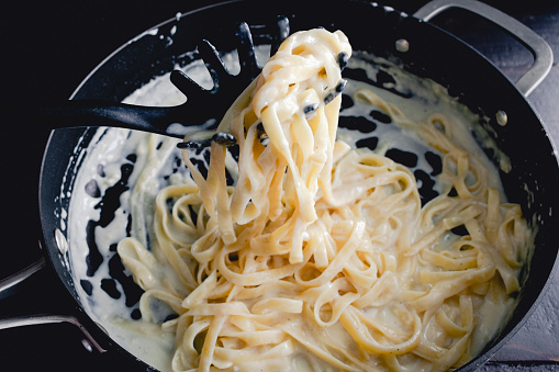 Freshly made noodles in a creamy parmesan cheese sauce