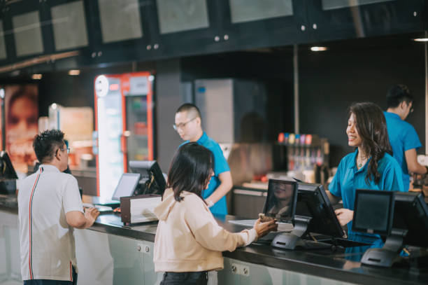 asian chinese customers buying movie tickets from cinema movie theater ticket counter asian chinese customers buying movie tickets from cinema movie theater ticket counter fast food stock pictures, royalty-free photos & images