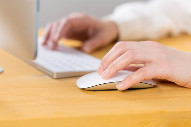 istock Close-up of young female hands pressing keyboard buttons and using a mouse. work from home. office. shopping 1328885610
