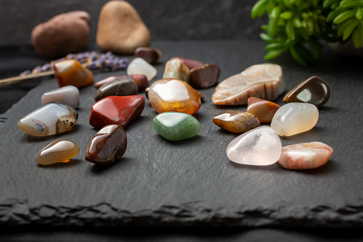 A view of a collection of smooth tumbled pebbles and stones, in a still life setting.