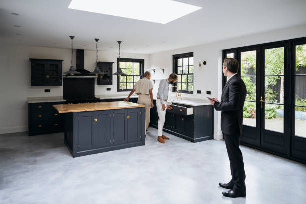 istock Prospective home buyers examining features of luxury kitchen 1328886177