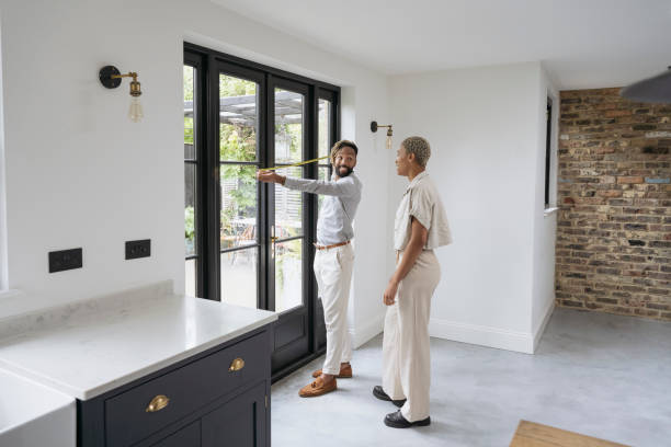 istock Prospective buyers taking measurements in luxury home 1328886183