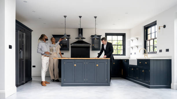 istock Black couple admiring pendant lights in Shaker-style kitchen 1328886184