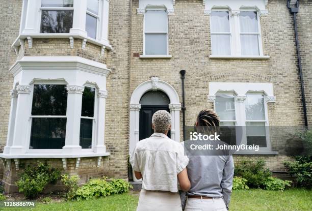 Portrait Of New Homeowners Admiring Their Investment Stock Photo - Download Image Now