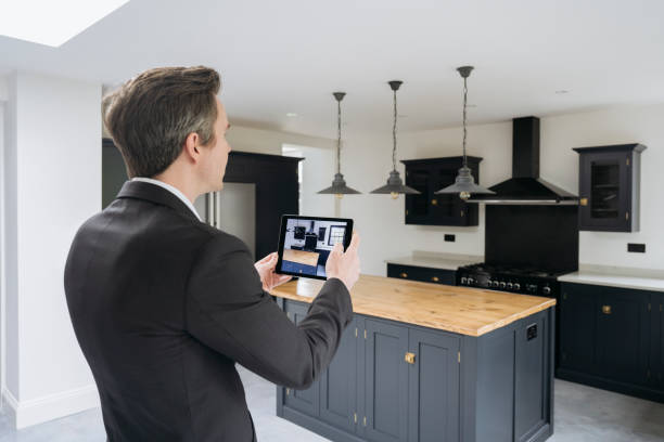 istock Real estate agent photographing kitchen with digital tablet 1328886204