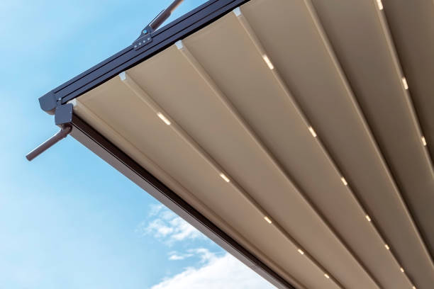 istock canvas awning with metal frame and drainage pipe against blue sunny sky. modern shading for house 1328887462