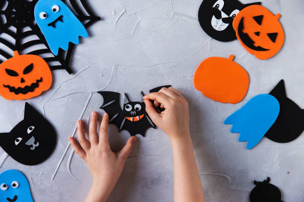 istock How to make decore for Halloween greetings and fun. Children art project. DIY concept. Step by step photo instruction. Step 6. Glued ears bat 1328888331