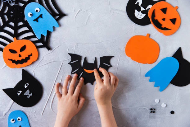 istock How to make decore for Halloween greetings and fun. Children art project. DIY concept. Step by step photo instruction. Step 2. Glued mouth bat 1328888337
