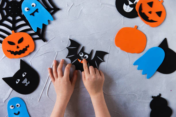 istock How to make decore for Halloween greetings and fun. Children art project. DIY concept. Step by step photo instruction. Step 5. Glued nose bat 1328888352