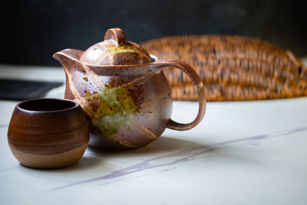 istock A teapot and a brown mug are Japanese ceramics, tea placed side by side. 1328889201