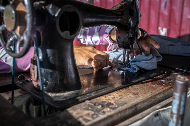 istock a woman is sewing clothes with her old sewing machine 1328894492