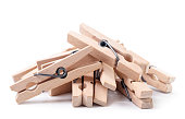A pile of wooden clothespins on a white background. Isolated