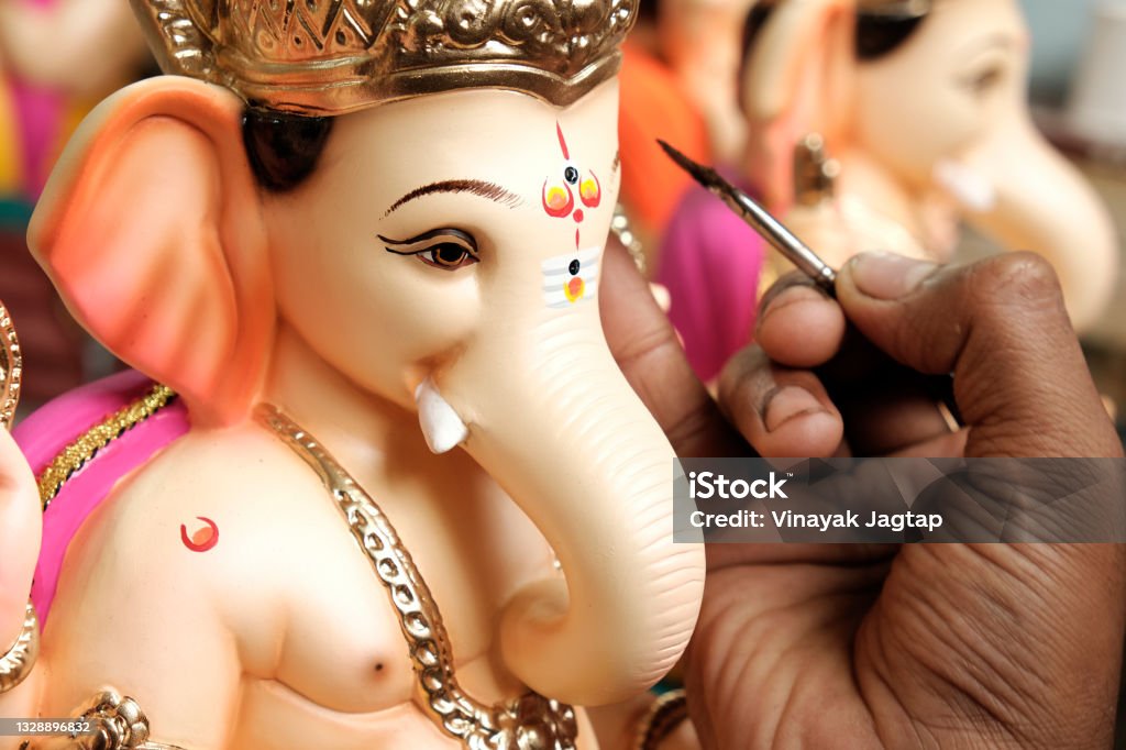 Artist painting and giving final touches to Lord Ganesha, ahead of "Ganesha Chaturthi" festival in Pune. Ganesha Stock Photo