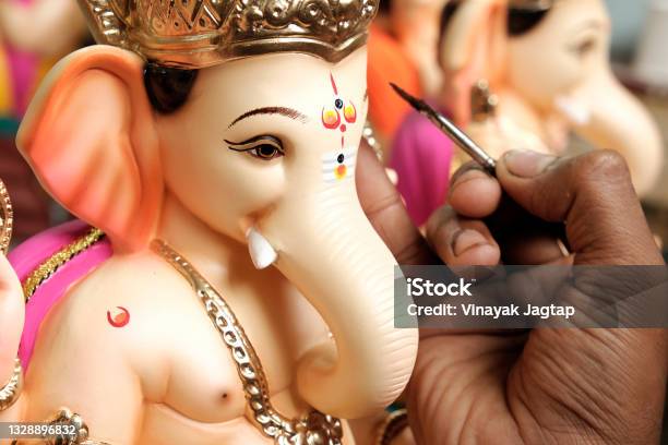 Artist Painting And Giving Final Touches To Lord Ganesha Ahead Of Ganesha Chaturthi Festival In Pune Stock Photo - Download Image Now