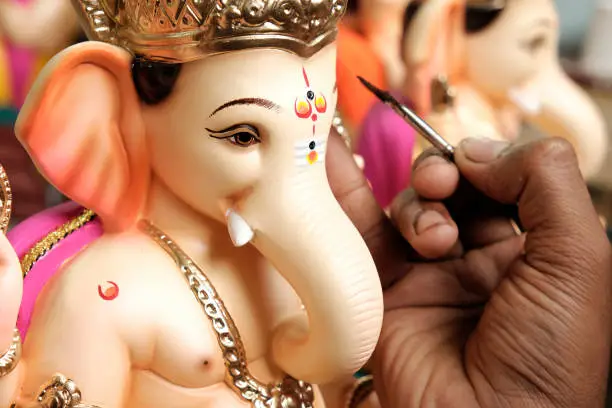 Artist painting and giving final touches to Lord Ganesha, ahead of "Ganesha Chaturthi" festival in Pune.