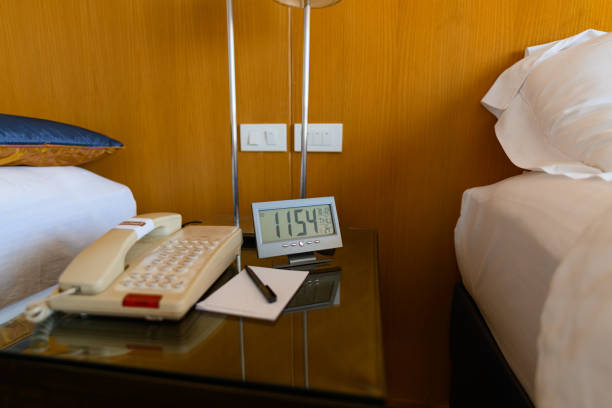 istock A digital clock is placed on a bedside table with wooden walls 1328896930