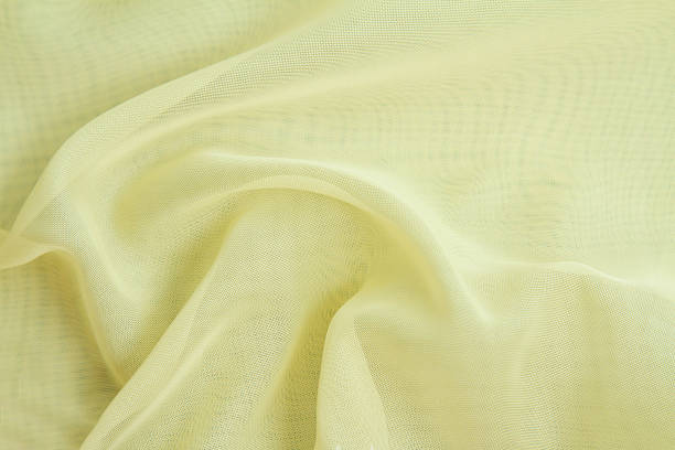 istock Yellow crumpled fabric background,light airy, transparent fabric texture. 1328896998