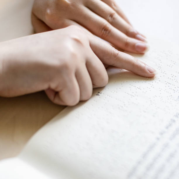 istock reading book with braille and usual text 1328898253