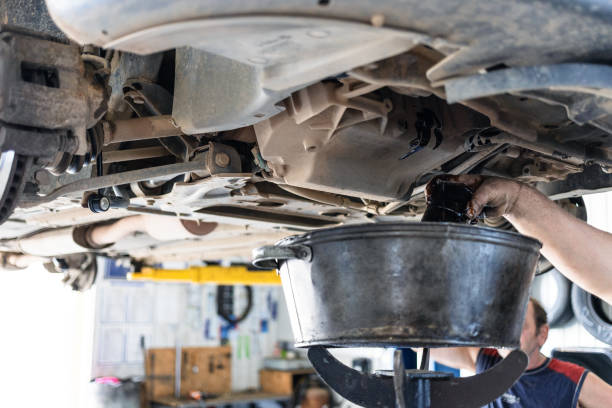 istock draining old engine oil from car in car workshop 1328898615