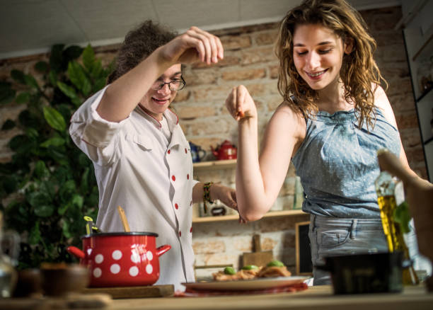 istock Playful young couple having dinner together. Eating spaghetti 1328899883