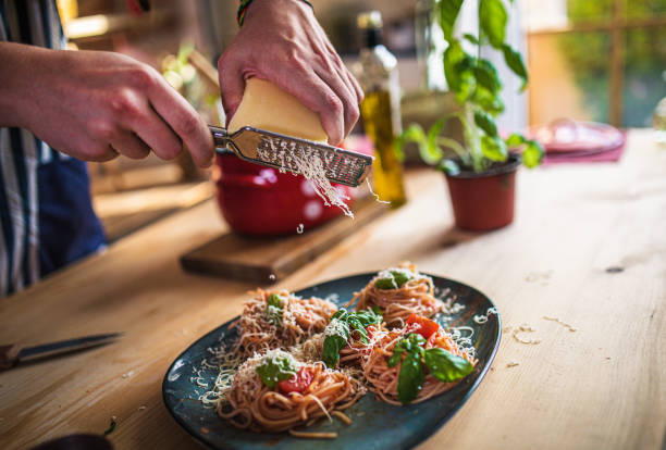 istock Playful young couple having dinner together. Eating spaghetti 1328900176