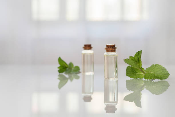 istock Mint essential oil in small glass bottles on the table. 1328902470