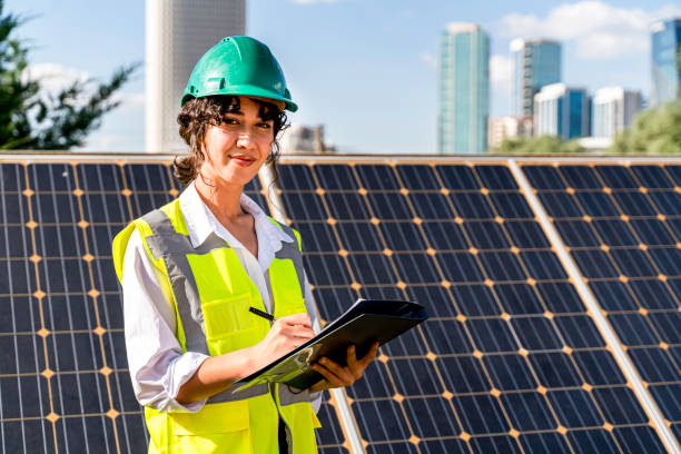 istock workers at a renewable energy plan, young woman working in solar power station 1328903784