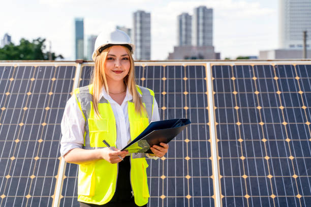 istock workers at a renewable energy plan, young woman working in solar power station 1328903870