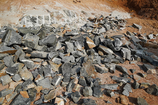 Natural Zeolite Rocks Are Excavated With Deforestation In Background.