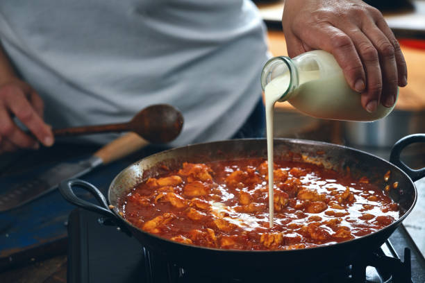 istock Preparing Indian Chicken Curry in Domestic Kitchen 1328905700