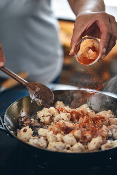 istock Preparing Indian Chicken Curry in Domestic Kitchen 1328905741
